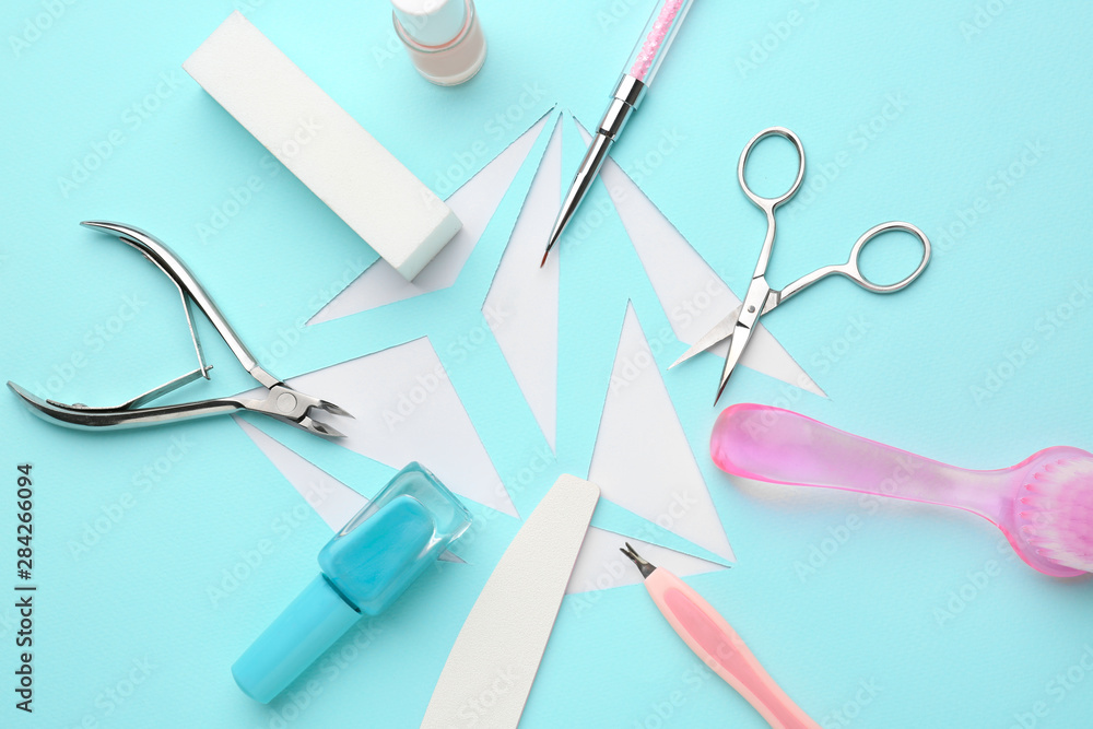 Supplies for manicure and pedicure on color background