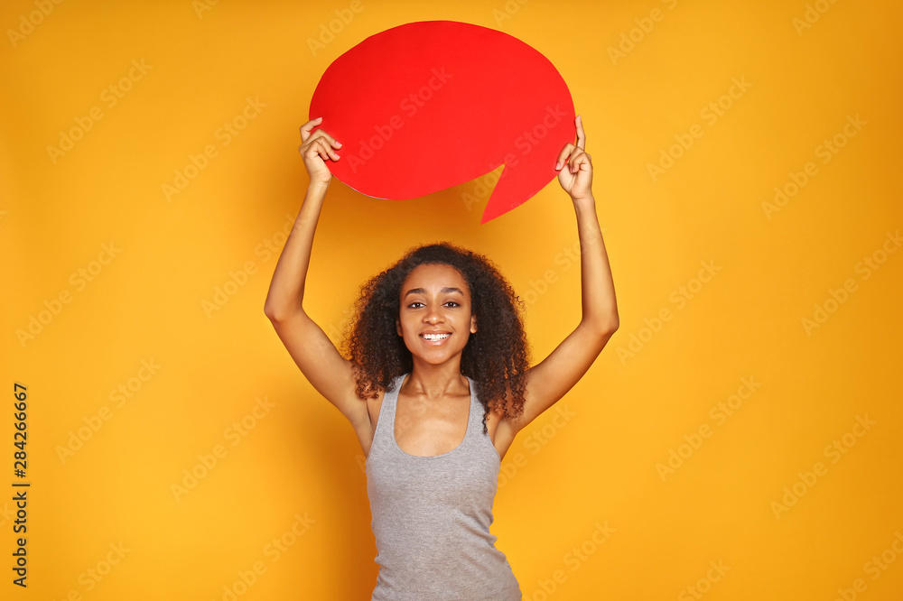 Portrait of beautiful African-American woman with blank speech bubble on color background