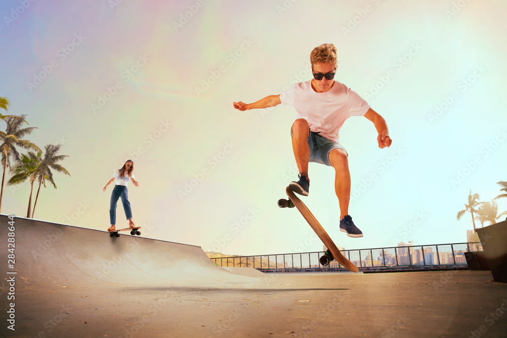 Skateboarder is performing tricks in skatepark on sunset.