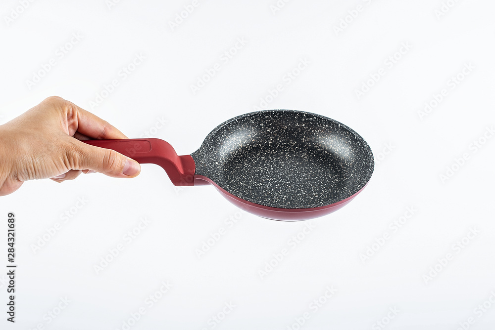 Hand holding an empty pan on a white background