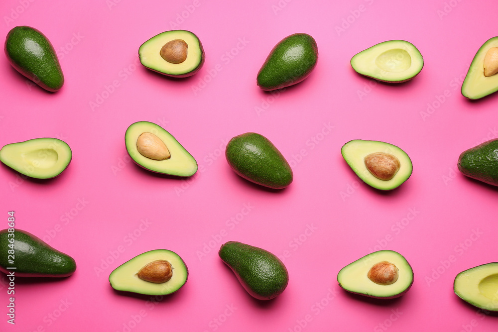 Fresh avocados on color background