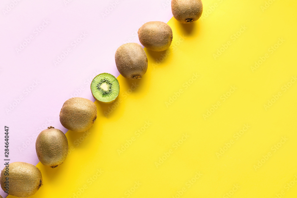 Whole kiwifruits and one half on color background. Concept of uniqueness