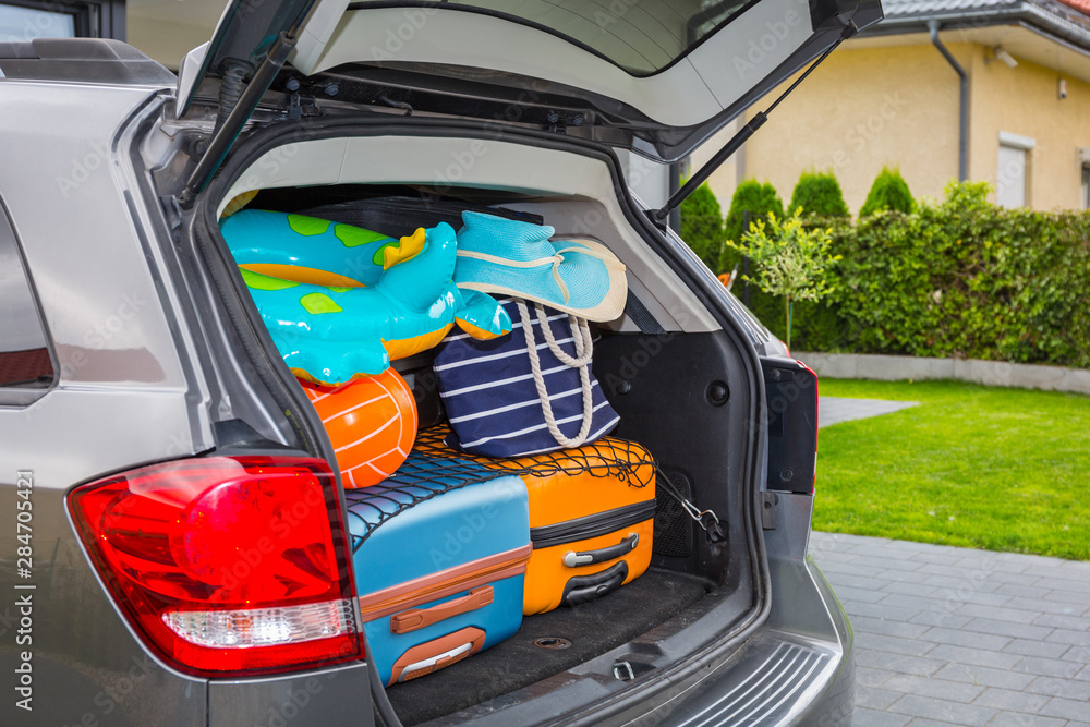 Baggages in the car trunk packed and ready to go for holidays