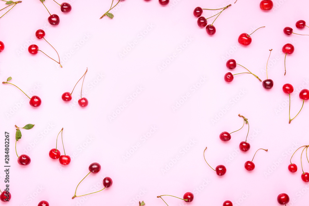 Frame made of ripe sweet cherry on color background