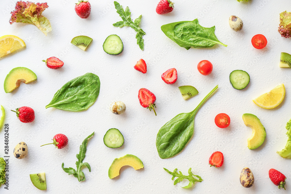 Herbs with strawberry, vegetables, fruits and egg on white background