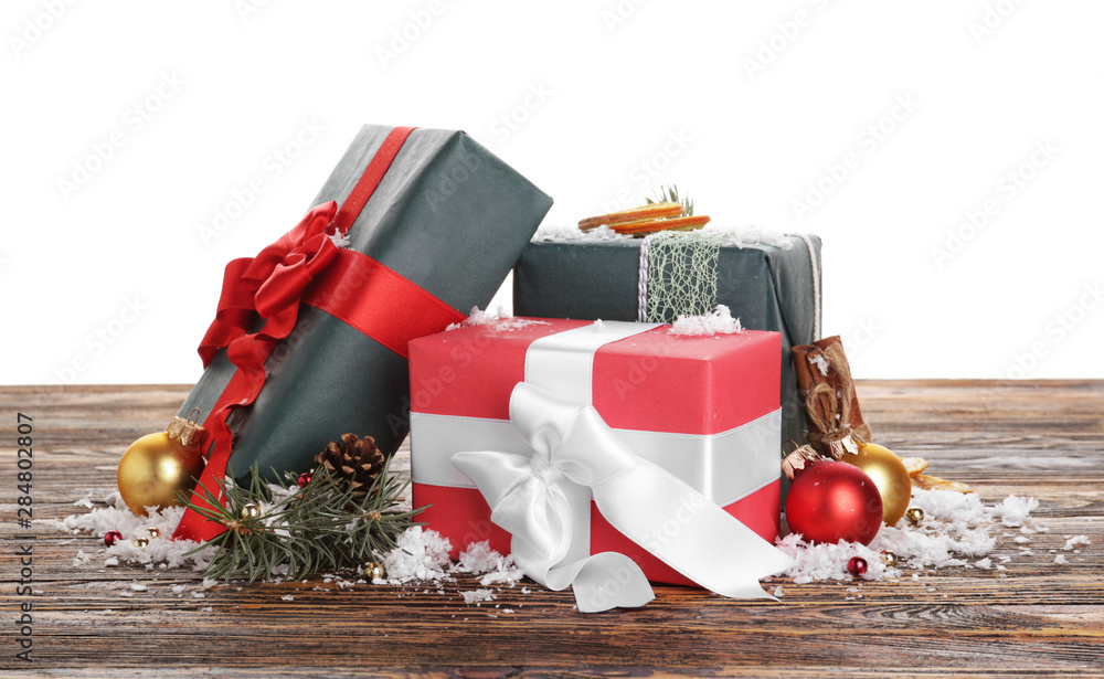 Beautiful Christmas gifts on wooden table against white background