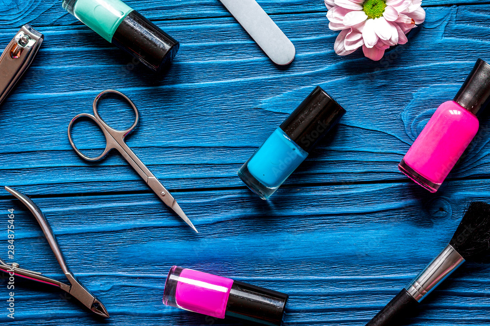 flower, nail polish and manicure set on dark wooden background