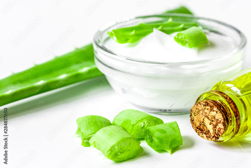 extract from aloe vera in glass bottle and cream macro