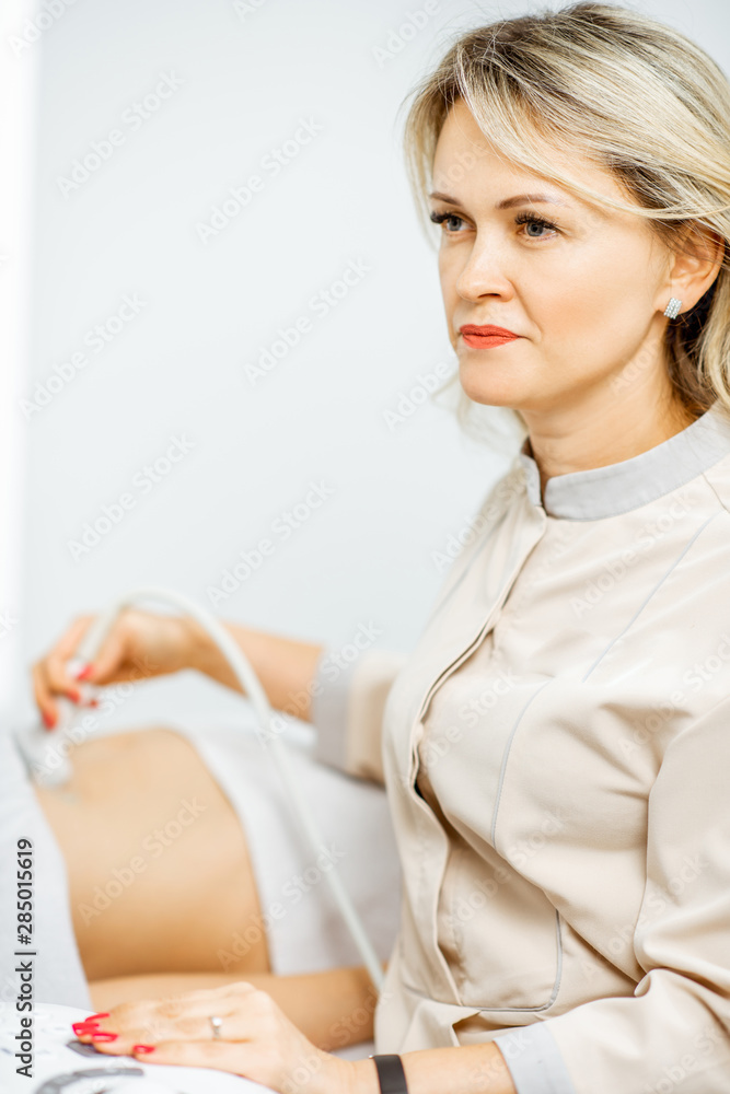 Doctor performs ultrasound examination of a woman