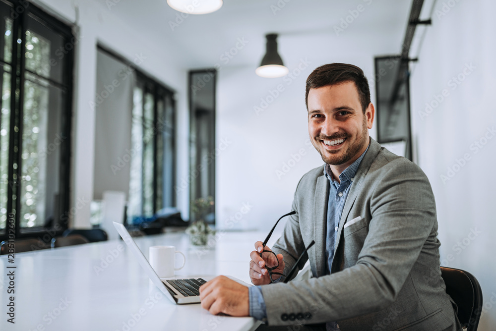 Portrait of successful bearded businessman in office.