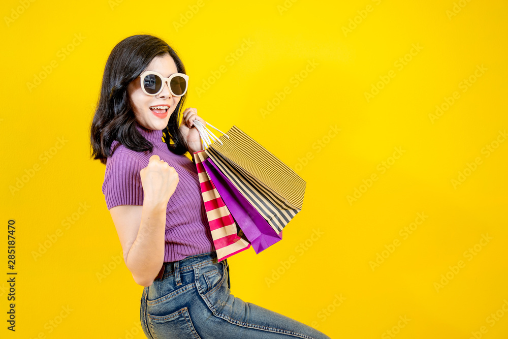 Shopping Woman concept, portrait or isolated an beautiful Asian woman wearing dress, hat and sunglas