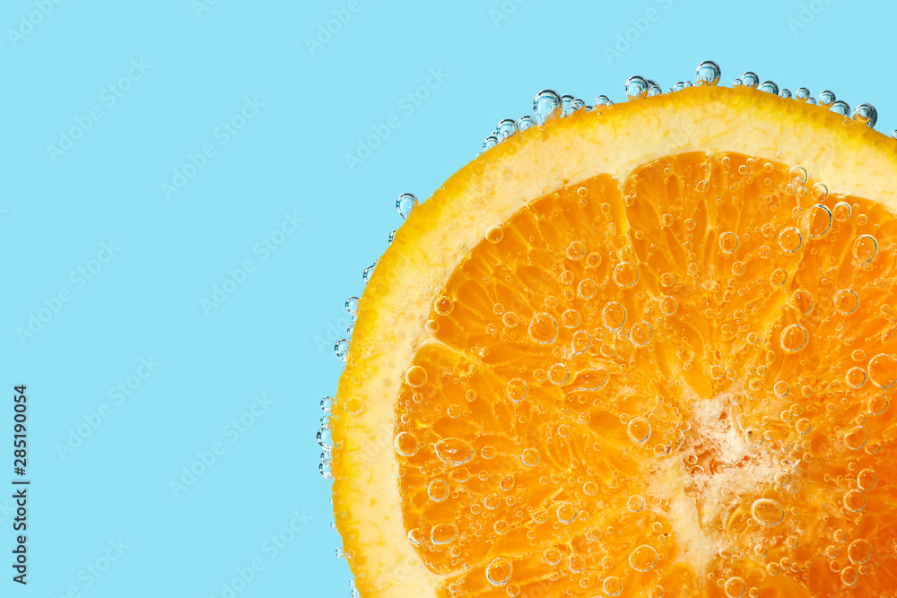 Ripe orange slice in water, closeup