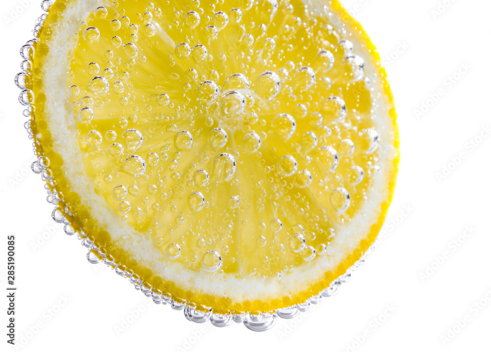 Ripe lemon slice in water, closeup