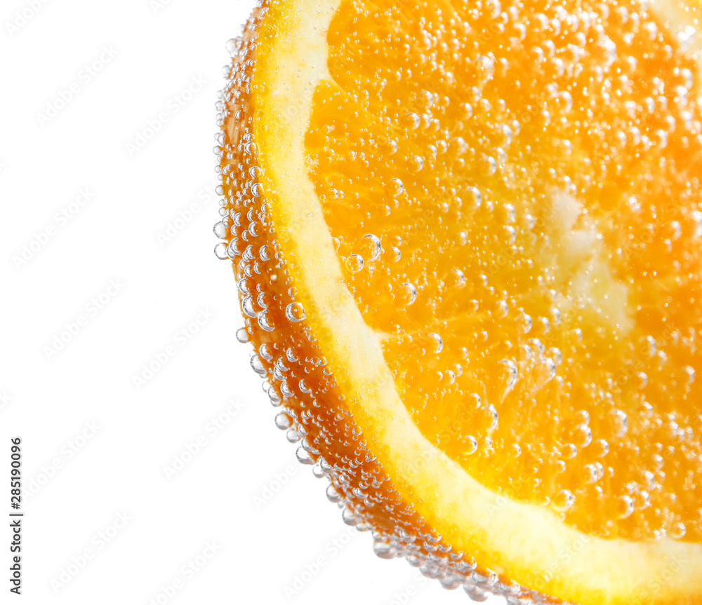 Ripe orange slice in water, closeup