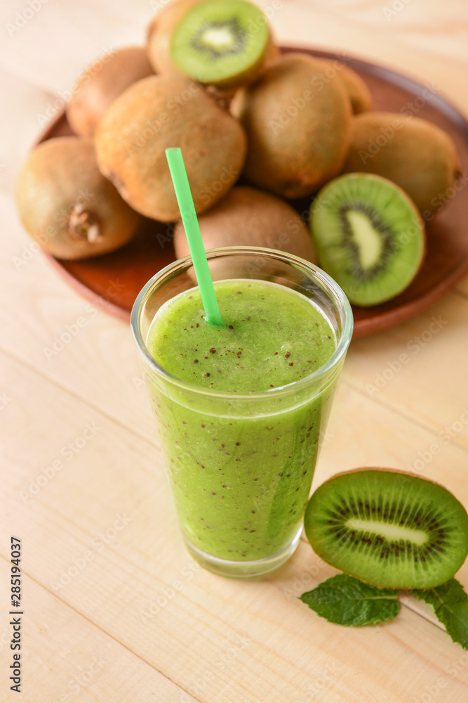 Glass of tasty kiwi smoothie on table