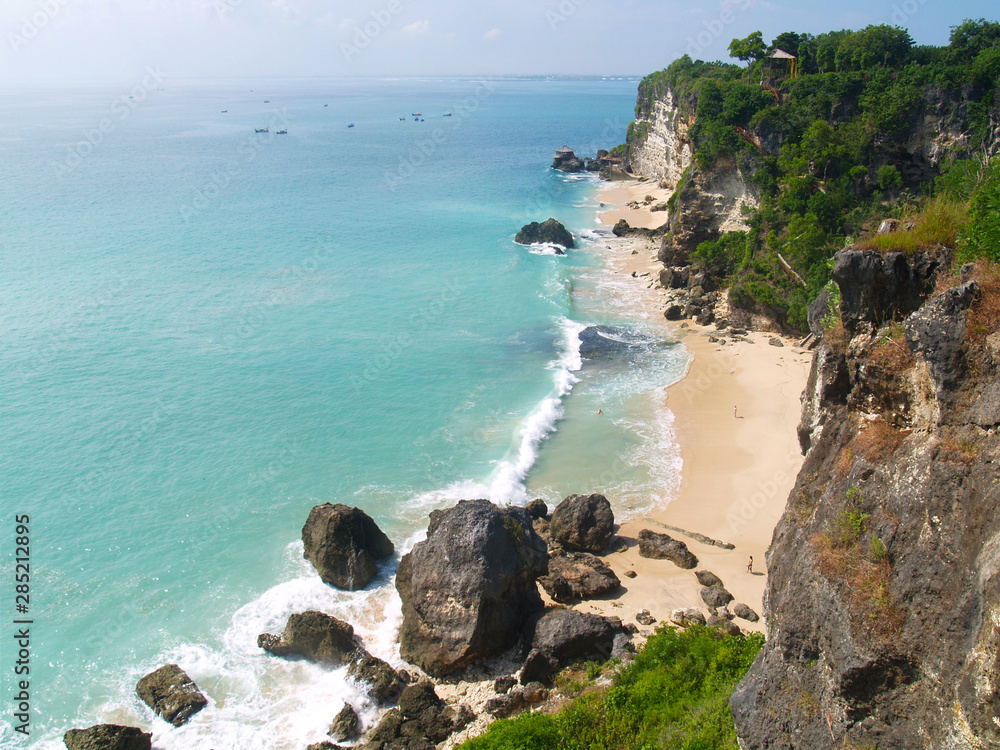 view of the coast with beach and coral at bukit in bali -indonesia