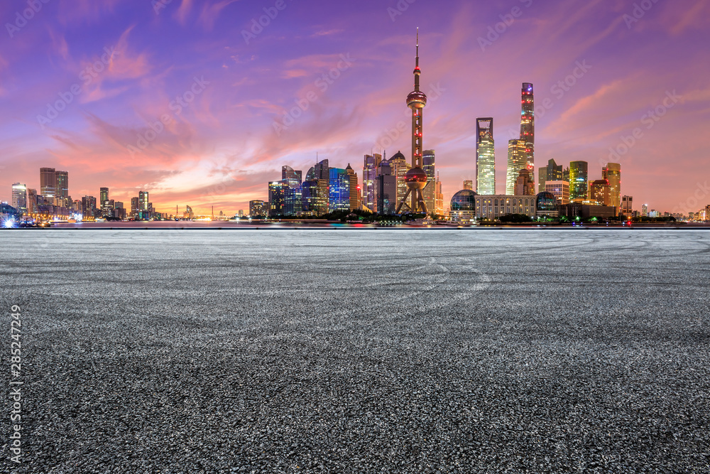 Shanghai skyline and modern buildings with empty race track at sunrise,China.