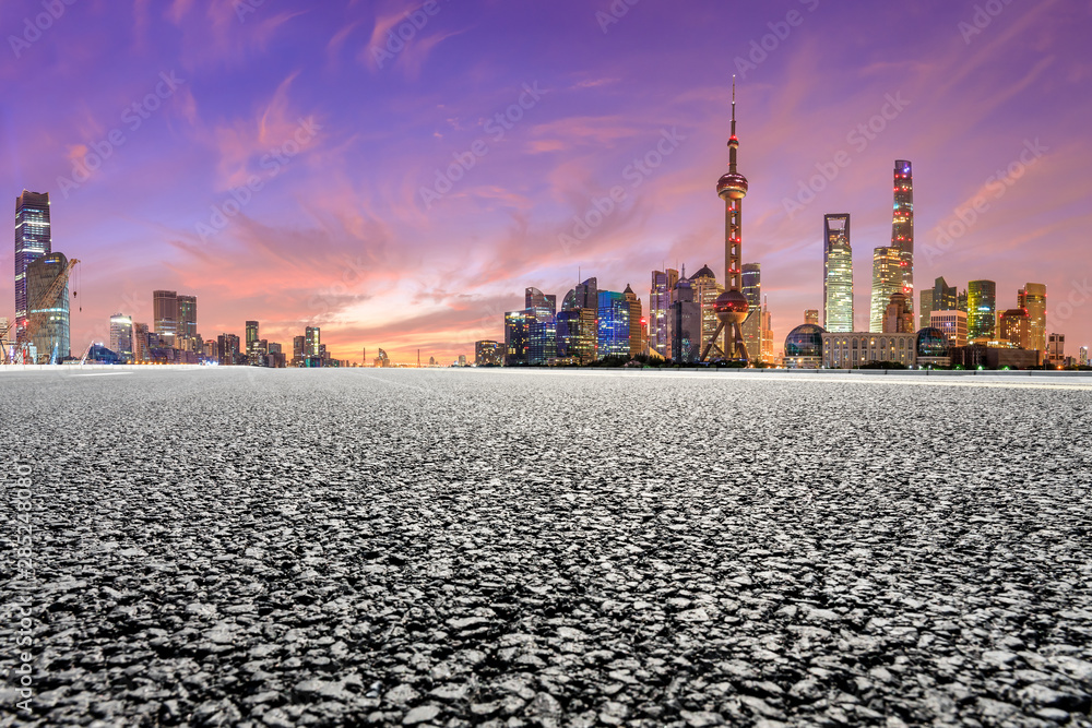 Shanghai skyline and modern buildings with empty asphalt highway at sunrise,China