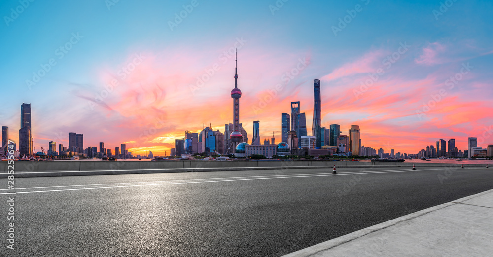 Shanghai skyline and modern buildings with empty asphalt highway at sunrise,panoramic view.