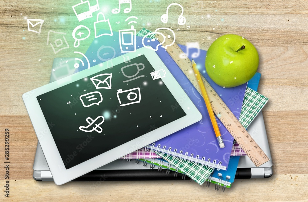 School supplies with tablet and laptop on background