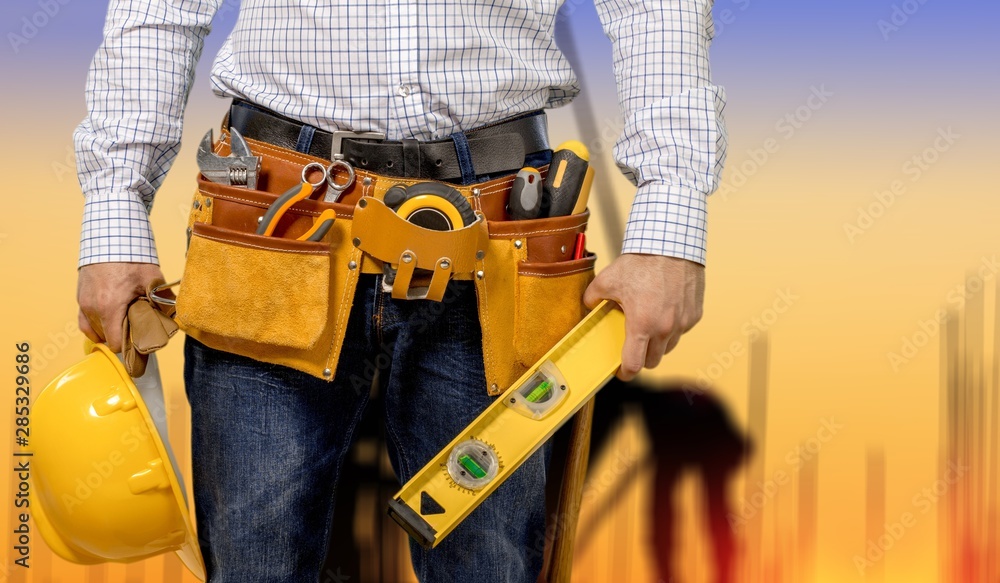 Worker with a tool belt. Isolated over  background.