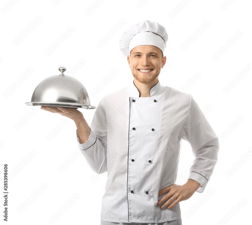 Handsome male chef with tray and cloche on white background