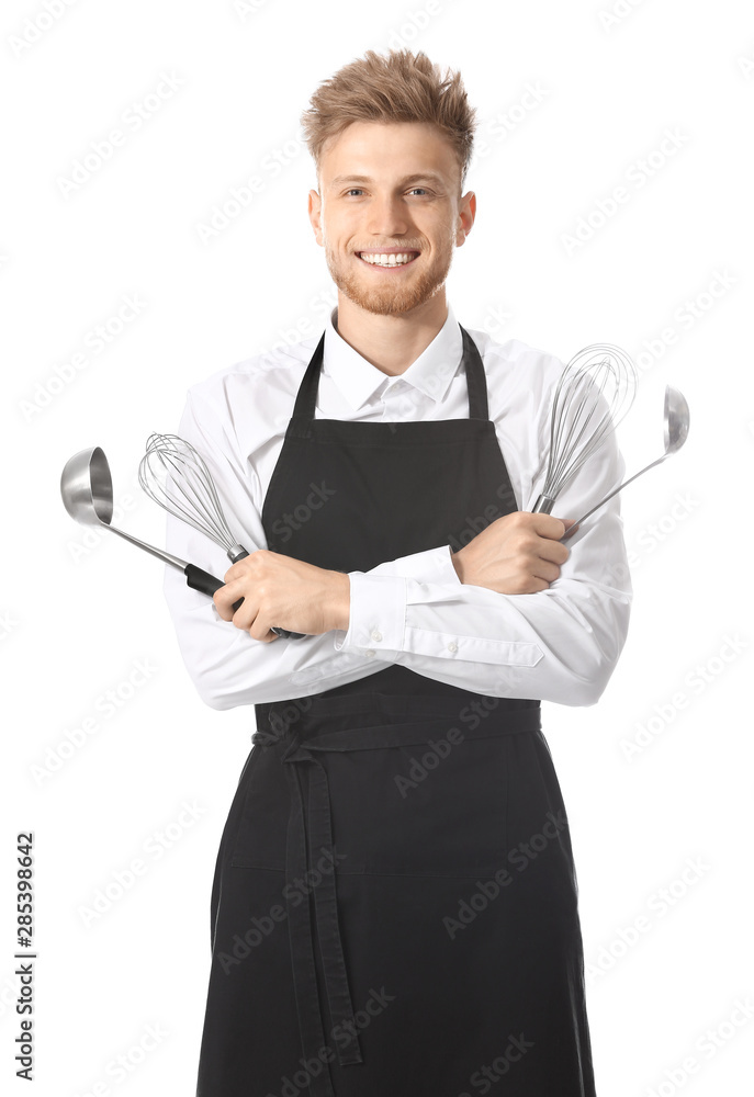 Handsome male chef with kitchenware on white background