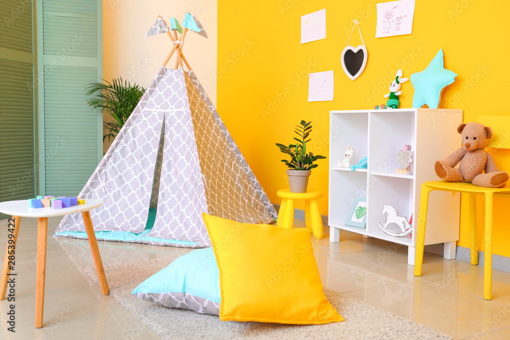 Interior of modern childrens room with teepee