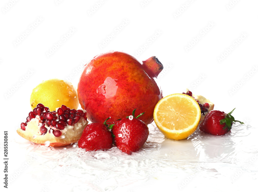 Ripe wet fruits on white background