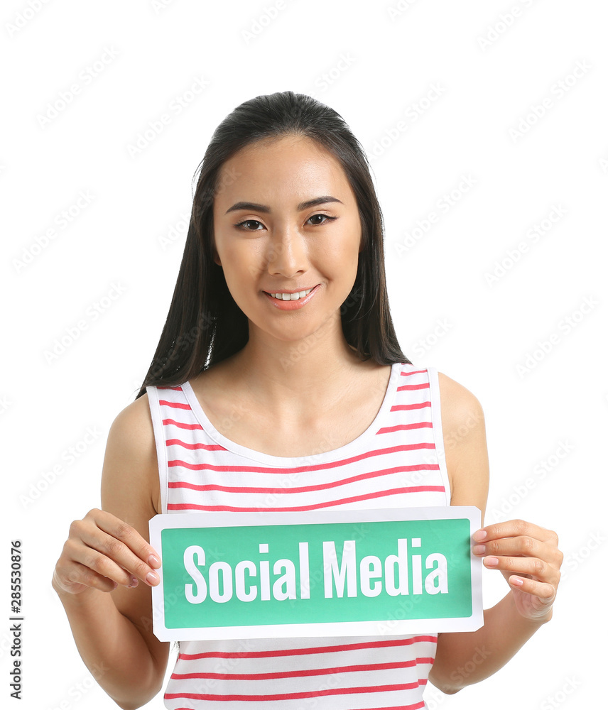 Female Asian blogger holding paper with text SOCIAL MEDIA on white background