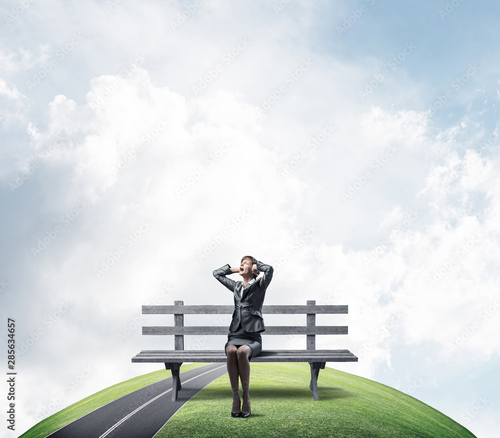 Stressful woman sitting on wooden bench