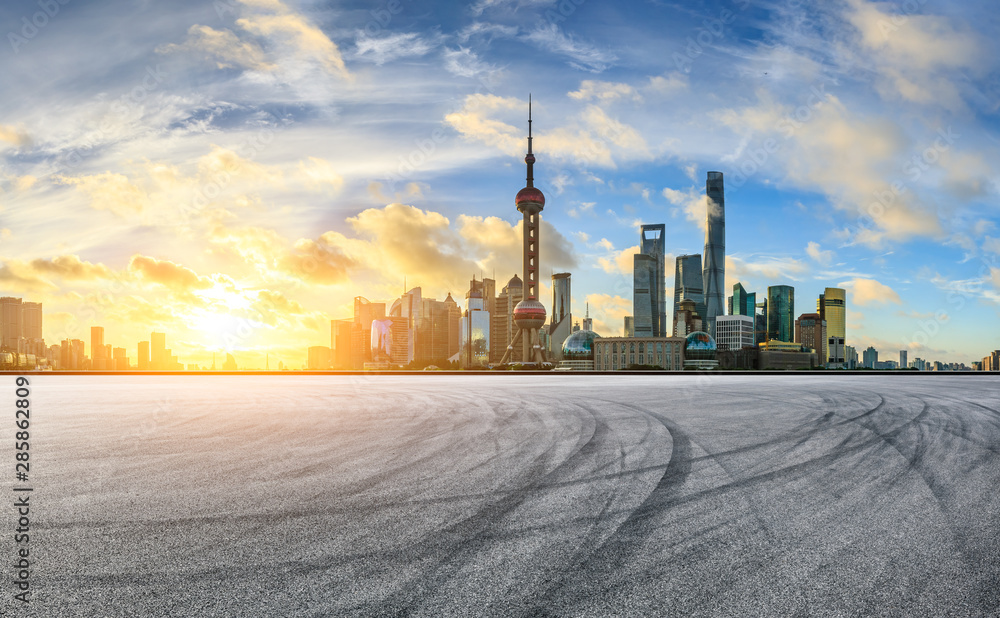 Empty race track and modern city scenery at sunrise in Shanghai,China.