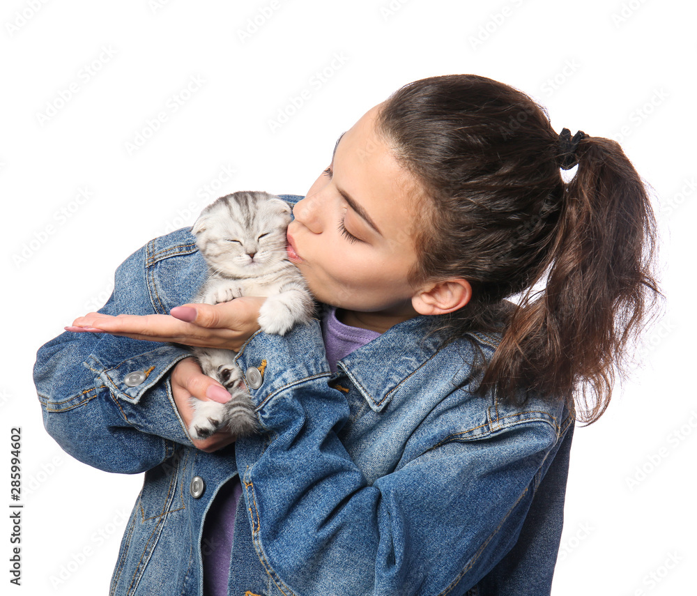 Beautiful young woman with cute little kitten on white background