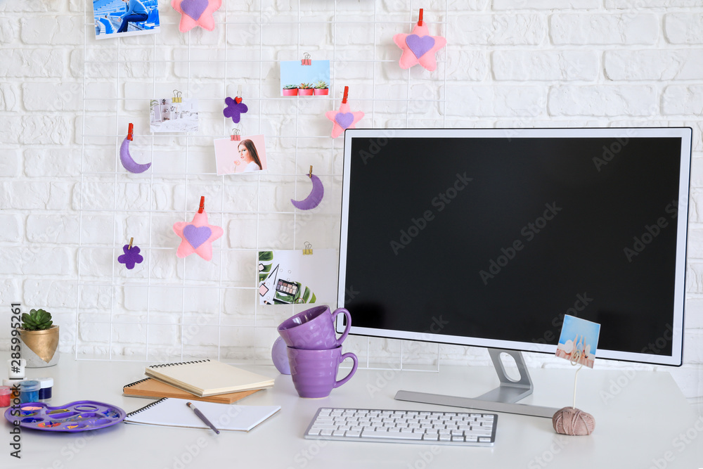 Workplace with mood board and computer in modern room