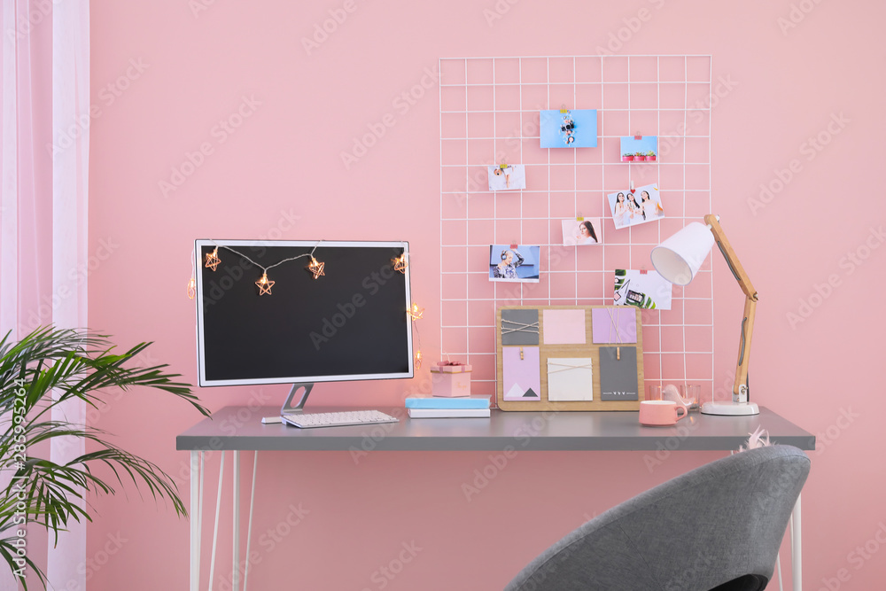 Workplace with mood board and computer in modern room