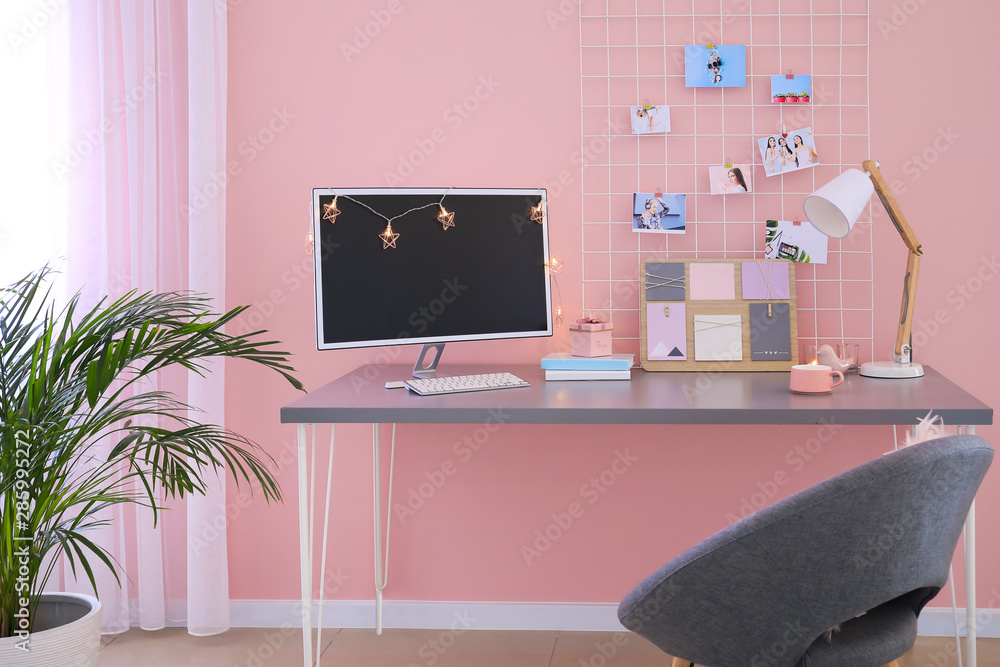 Workplace with mood board and computer in modern room