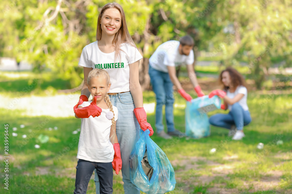 Volunteers gathering garbage in park