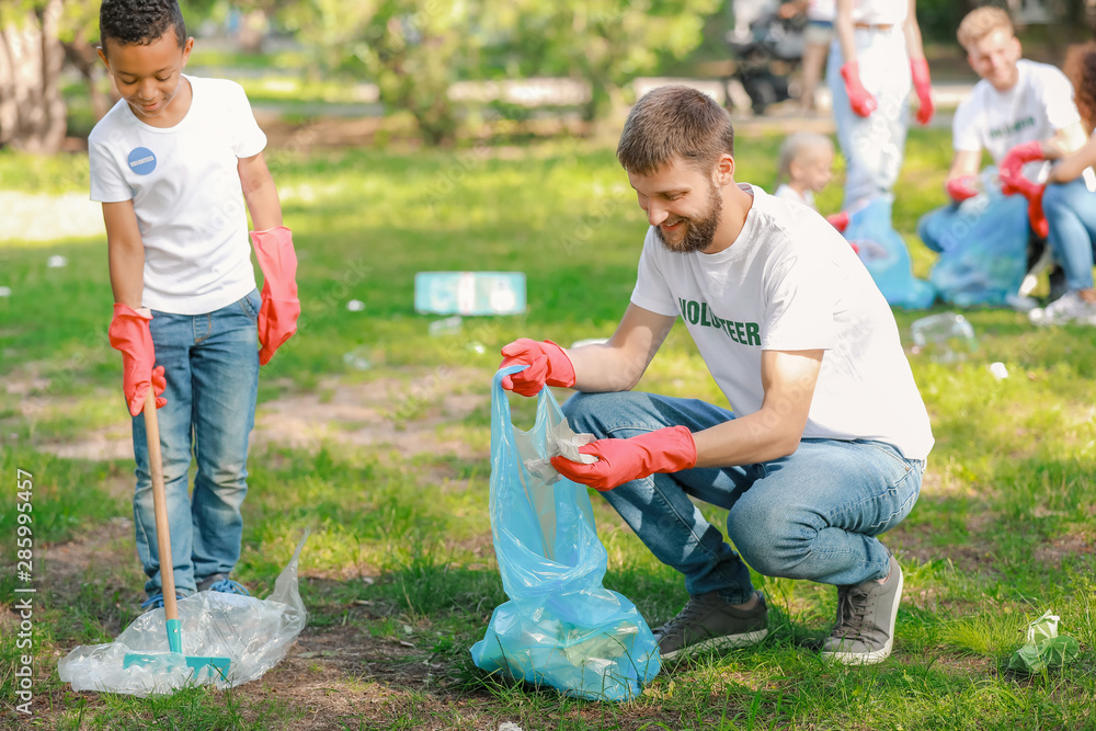 Volunteers gathering garbage in park