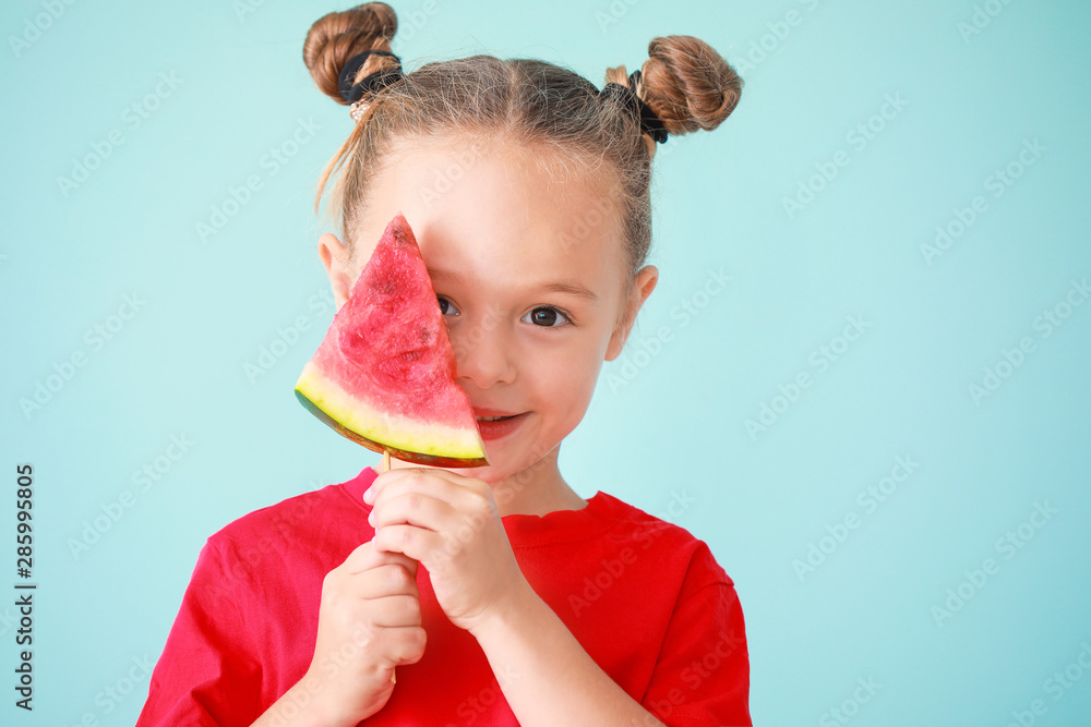 Cute little girl with slice of fresh watermelon on color background