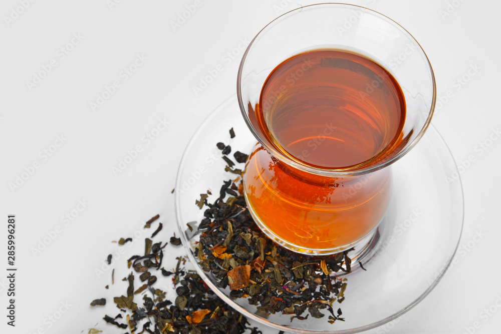 Glass cup of tasty tea on white background