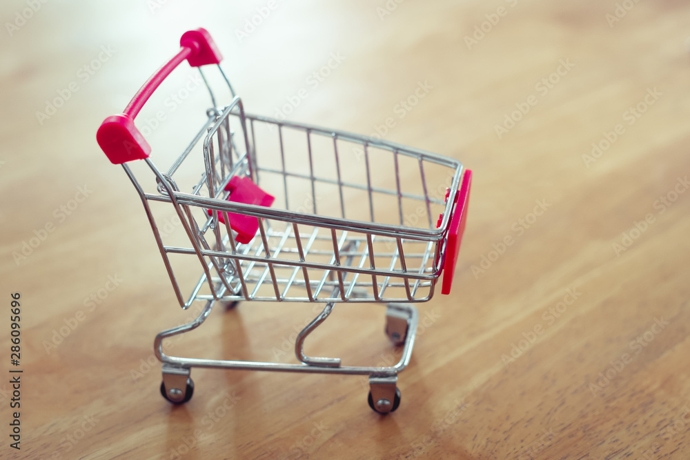 shopping cart on table and sunlight background shopping online concept of modern market