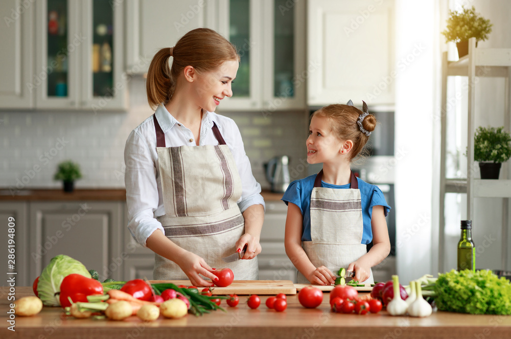 happy family mother with child girl preparing vegetable salad .