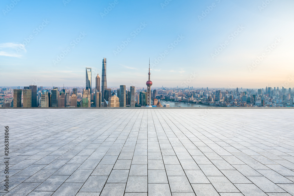 Empty square floor and city skyline with buildings at sunset in Shanghai,China.