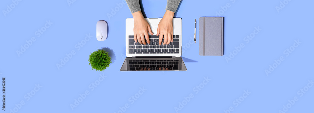 Person using a laptop computer from above