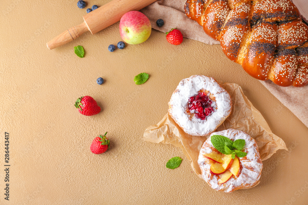 Sweet pastry with fruits on color background