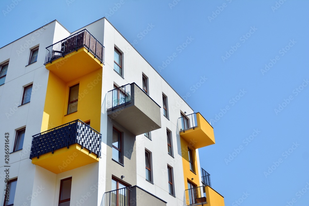 Modern apartment buildings on a sunny day with a blue sky. Facade of a modern apartment building