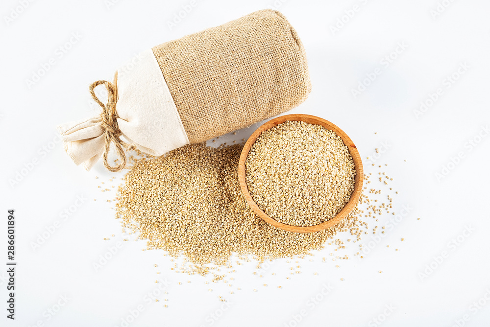 Sacks filled with grain and a bowl of buckwheat on a white background