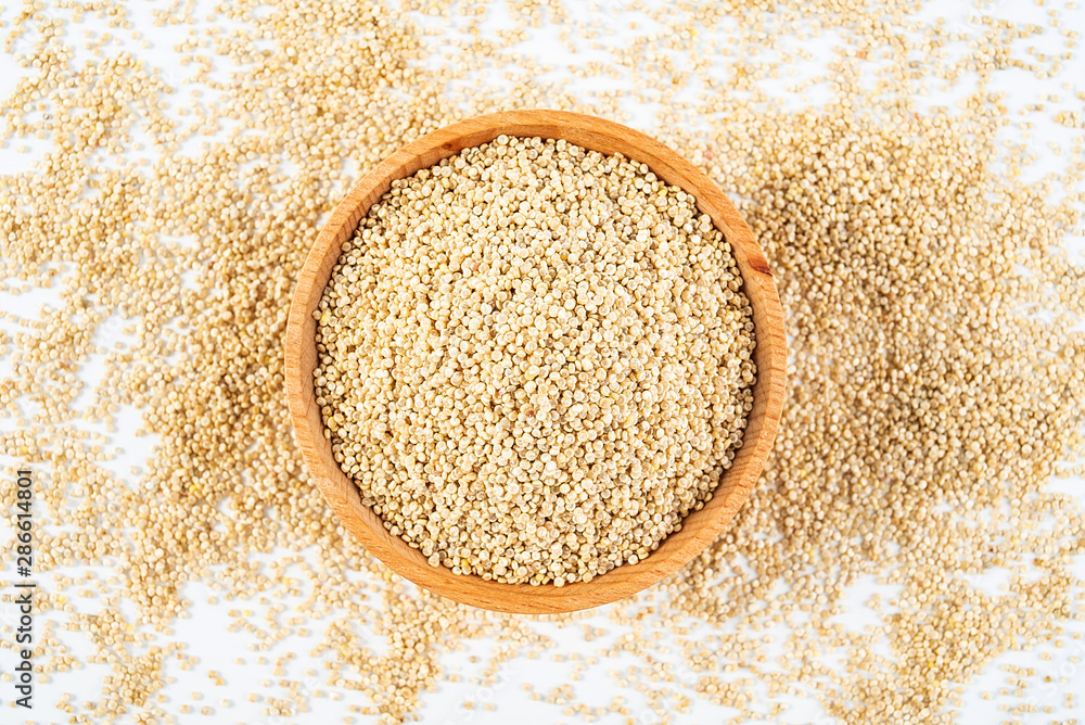 A wooden bowl of miscellaneous grains buckwheat on a white background