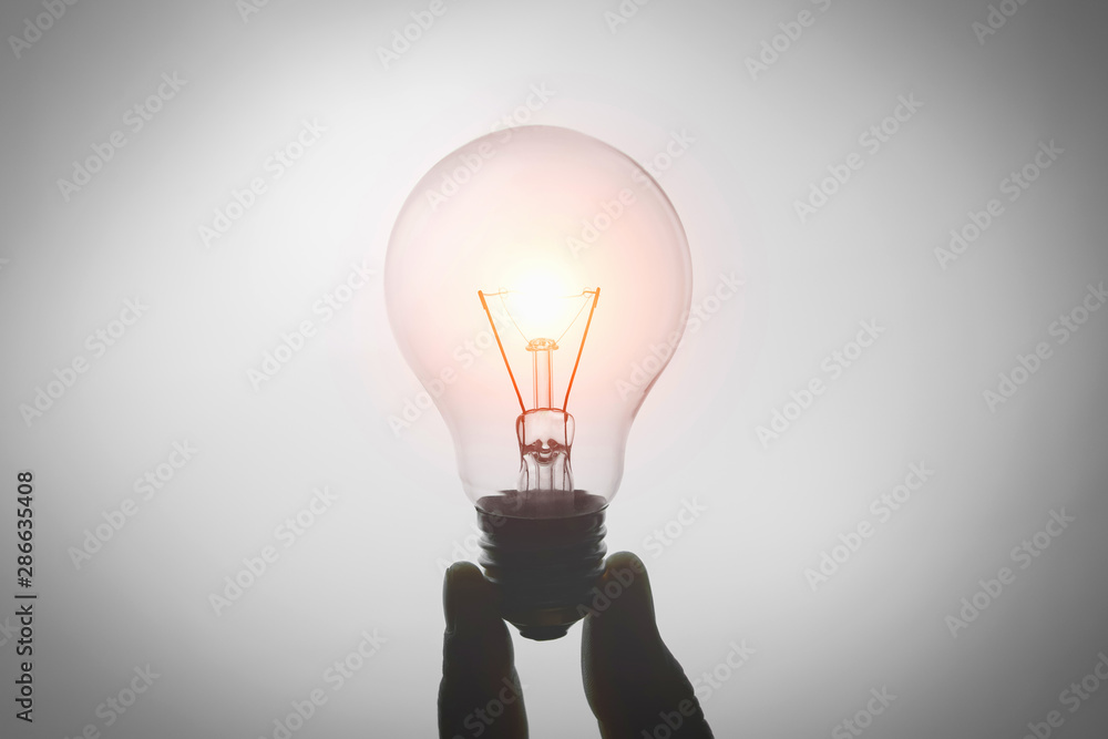 hand holding light bulb isolate on white background