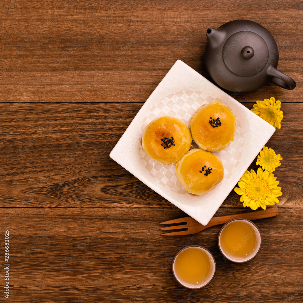 Moon cakes with tea on dark wooden table, holiday concept of Mid-Autumn festival traditional food la